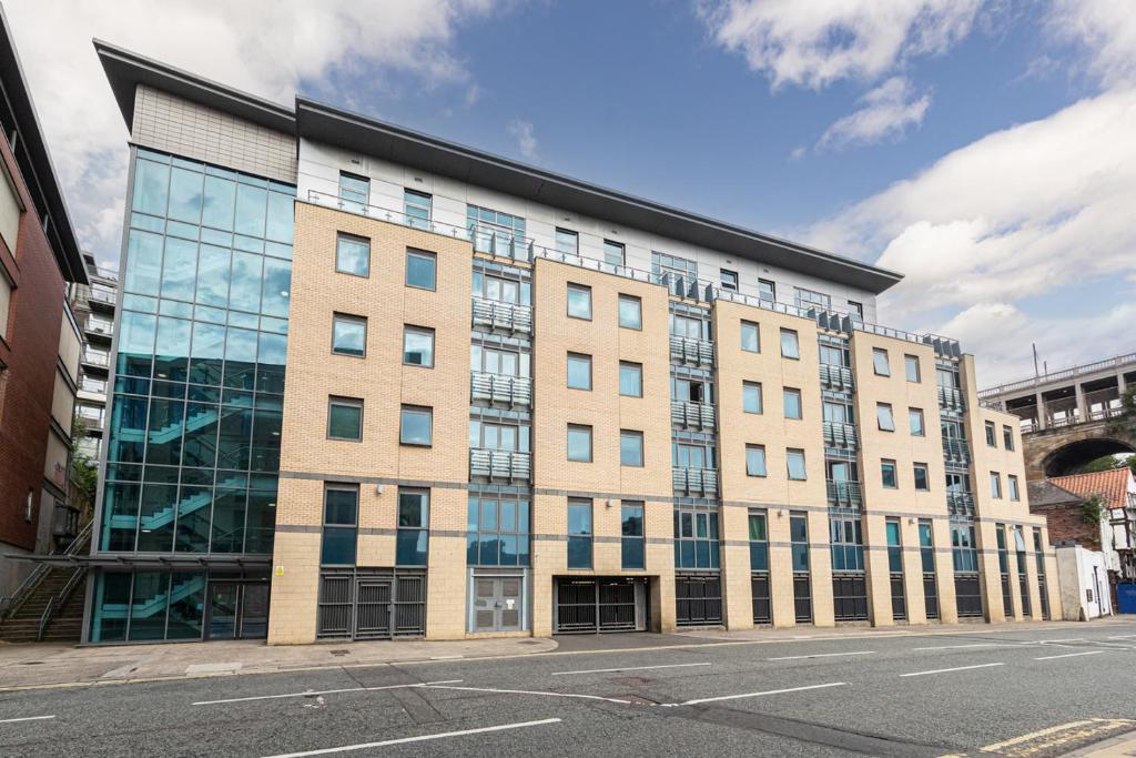 a large building with glass windows on a street at 30 Quayside Newcastle in Newcastle upon Tyne