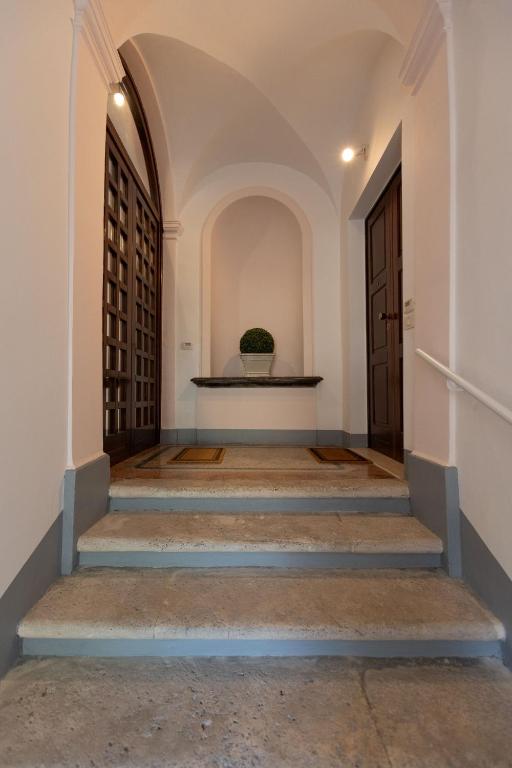 un corridoio con scale che conducono a una porta di Palazzo Antico ad Ascoli Piceno