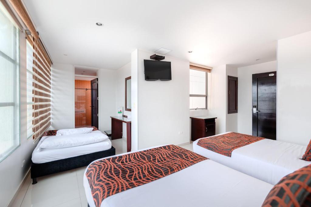 Postel nebo postele na pokoji v ubytování Hotel Parque 63