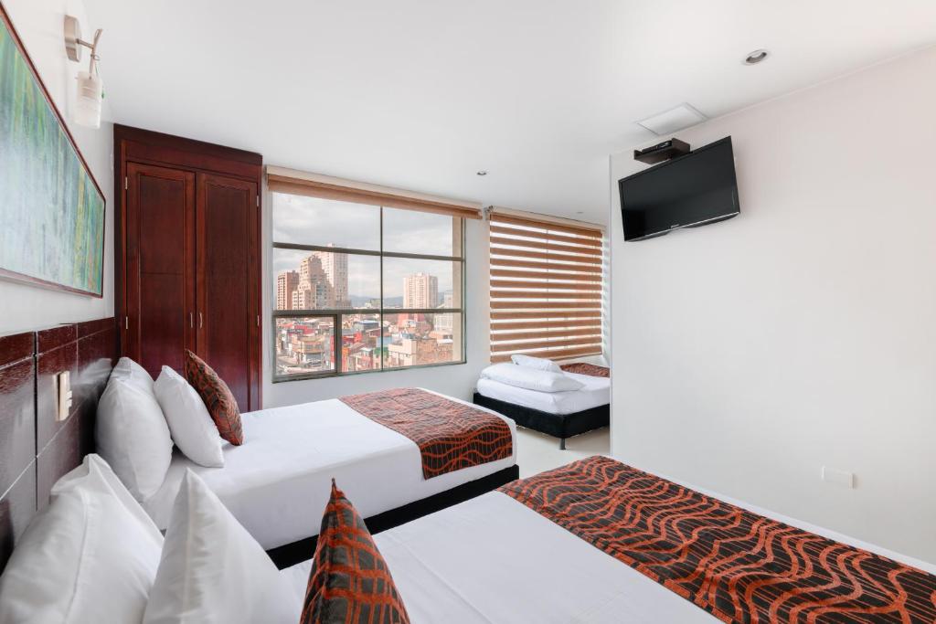 Postel nebo postele na pokoji v ubytování Hotel Parque 63