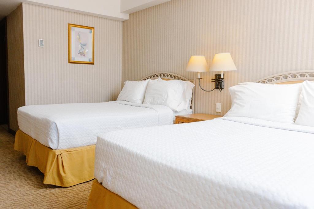 Postel nebo postele na pokoji v ubytování Intercity Tower Hotels