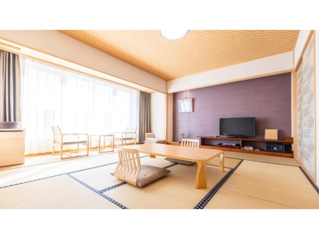 a living room with a table and a tv at Sansuien - Vacation STAY 06800v in Kochi
