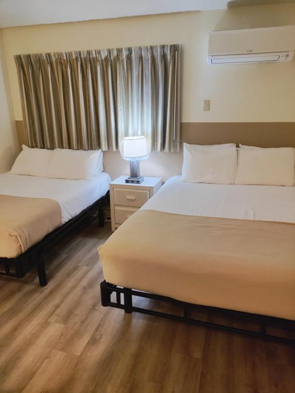 Postel nebo postele na pokoji v ubytování Condor Motel - Beach Block