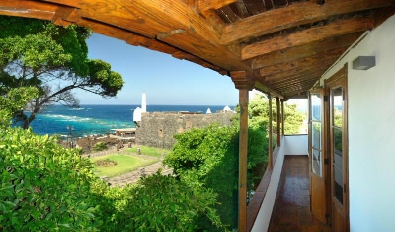 a balcony of a house with a view of the ocean at Isla Baja Suites in Garachico