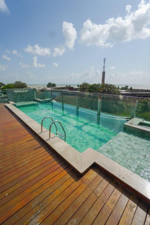 a swimming pool on the roof of a building at Israel flat Tambau 115 in João Pessoa