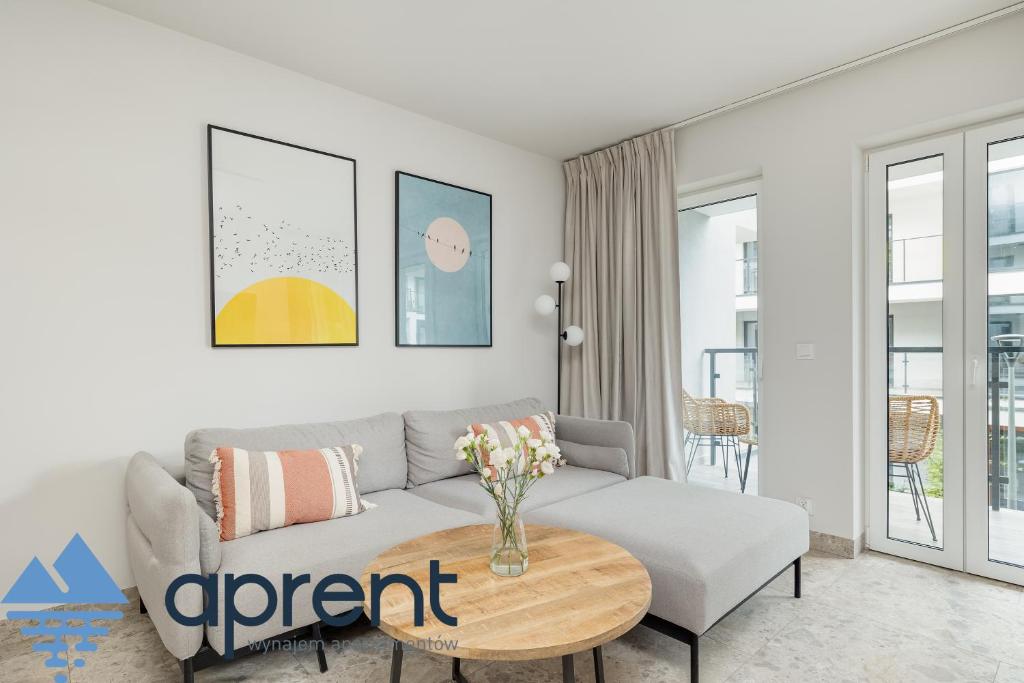 a living room with a couch and a table at Apartament Sun&Moon PBA - Aprent in Pobierowo