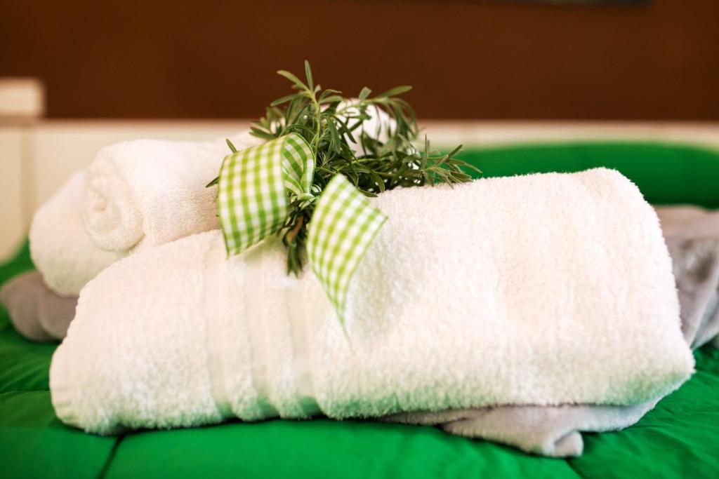 a pile of towels with a plant on top at Le Case Di Rosella in Vico Equense