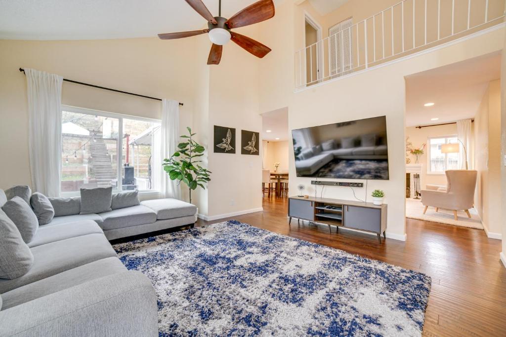 a living room with a couch and a ceiling fan at Furnished Deck and Grill Reno Getaway! in Reno
