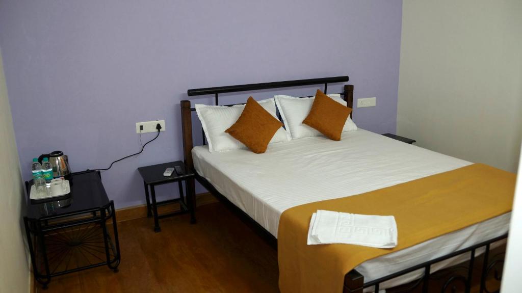 Postel nebo postele na pokoji v ubytování Betelnut Inn
