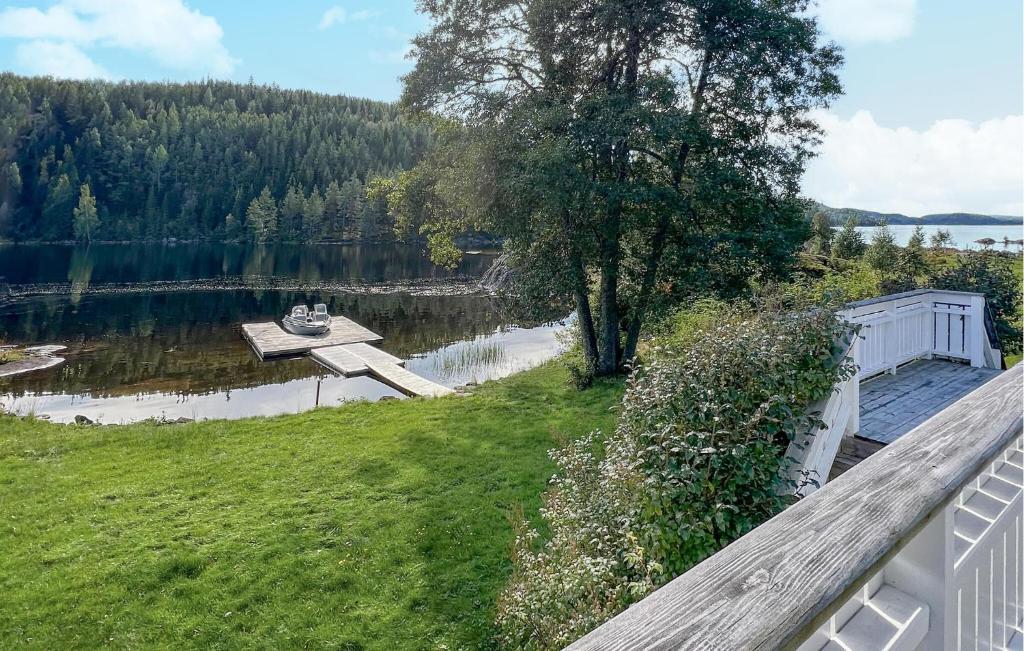 a view of a lake with a wooden dock at 2 Bedroom Gorgeous Home In Vegårshei in Vegårshei