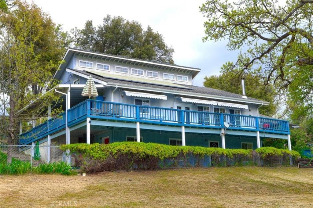 a large house with a blue porch and balcony at Beautiful Pet-Friendly Spacious Lodge near Yosemite & Lakes 12 Beds 6 BR up to 16 people in Oakhurst