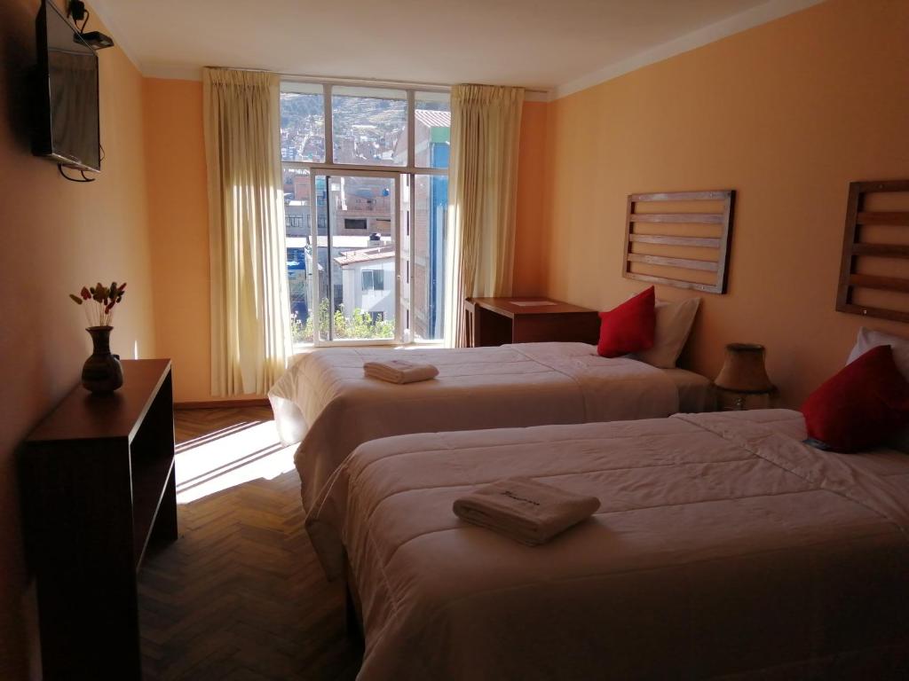 Postel nebo postele na pokoji v ubytování Huaytusive Inn Hotel