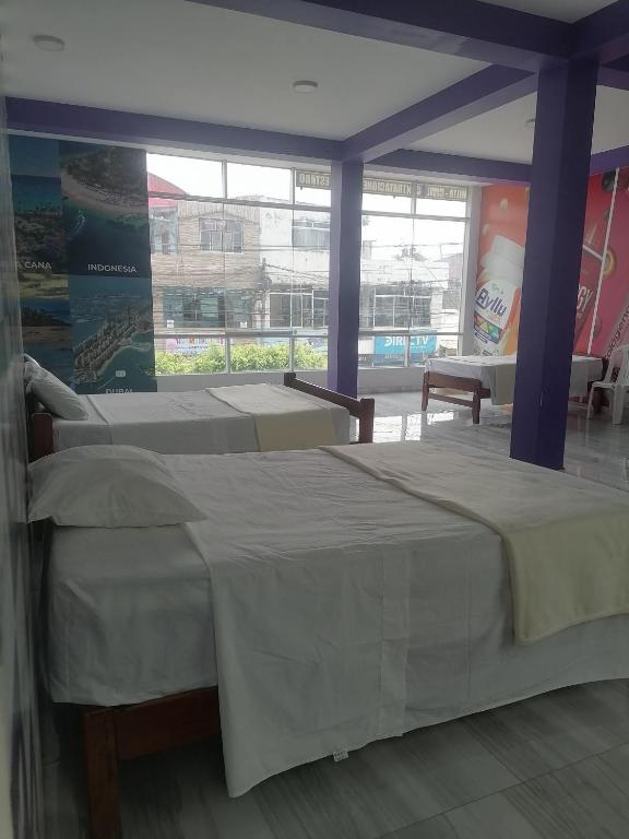 Postel nebo postele na pokoji v ubytování Ayahuasca Hostel