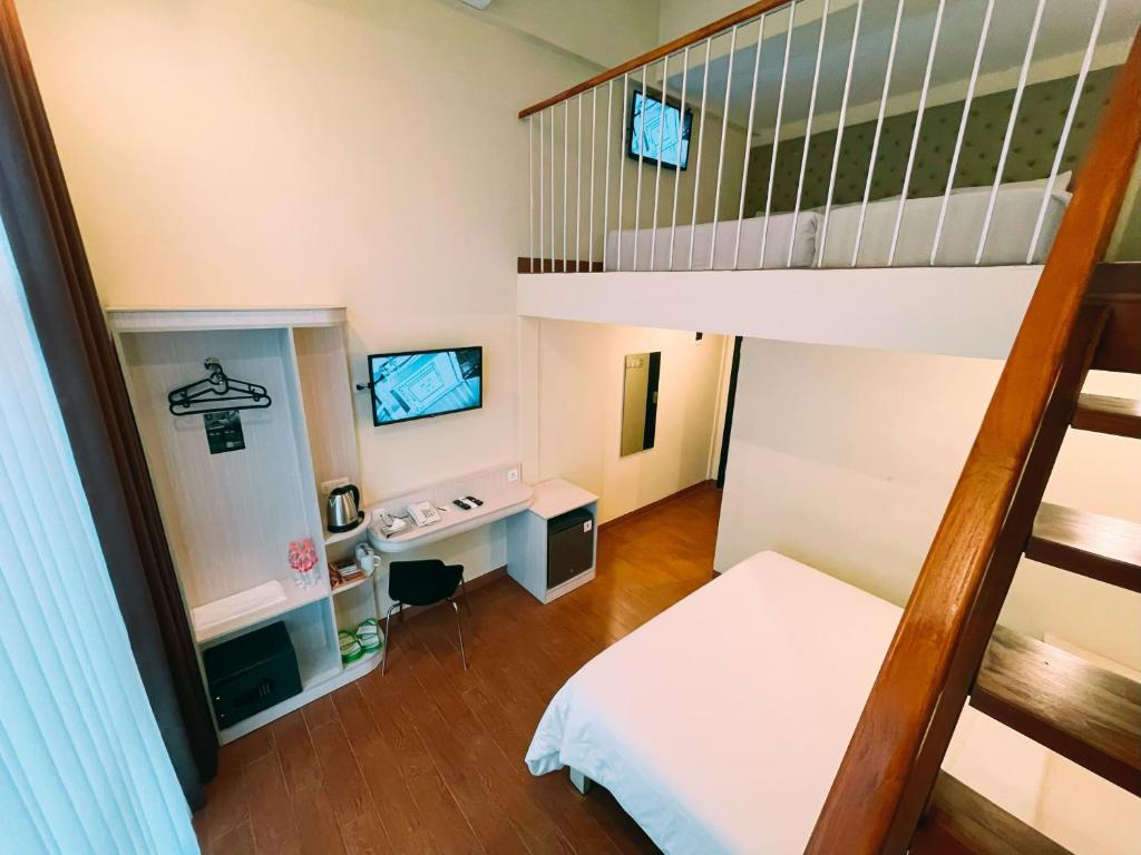 Postel nebo postele na pokoji v ubytování Tebu Hotel Bandung