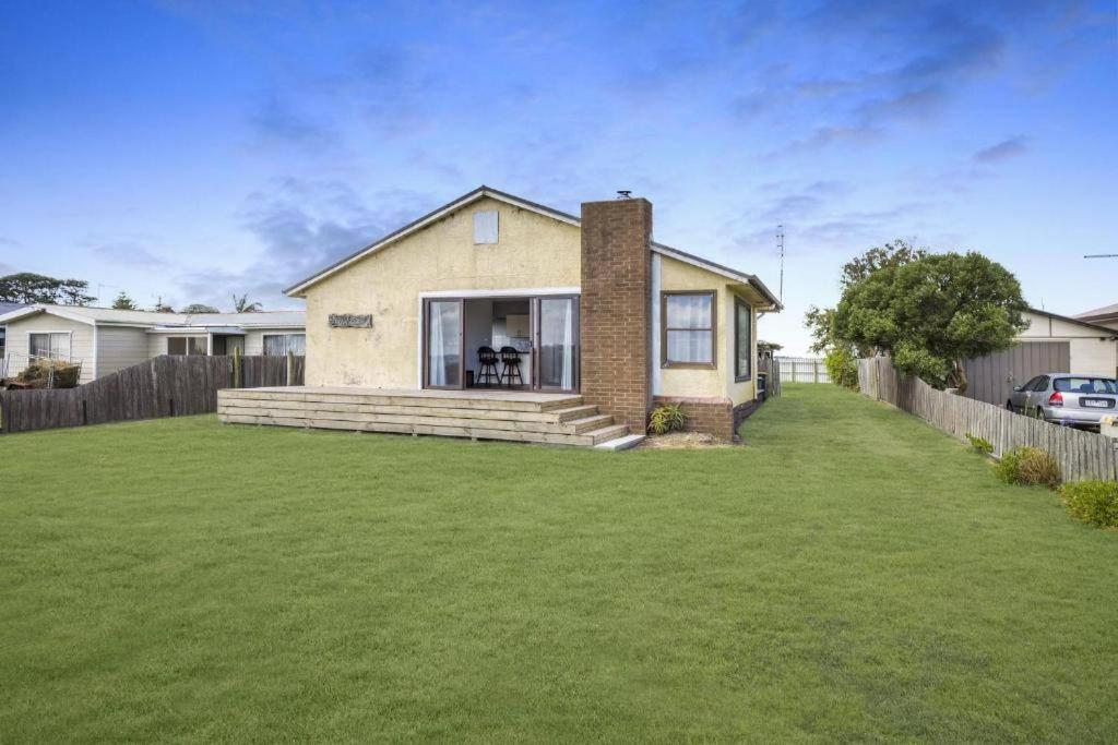 a house with a lawn in front of it at Seaspray home in Tarraville