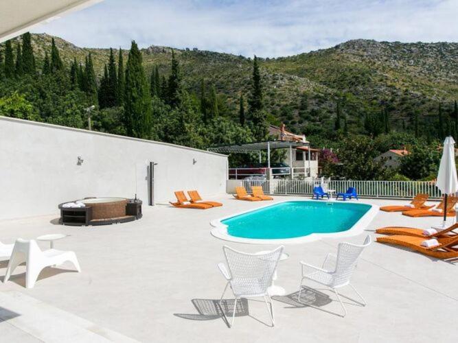 a patio with chairs and a swimming pool at Five Bedroom Villa with Private Pool & Sea View in Zaton
