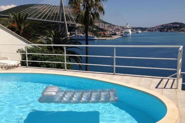 a swimming pool with a view of the water at Apartments Lozica - Standard Studio Apartment with Terrace and Sea View in Dubrovnik