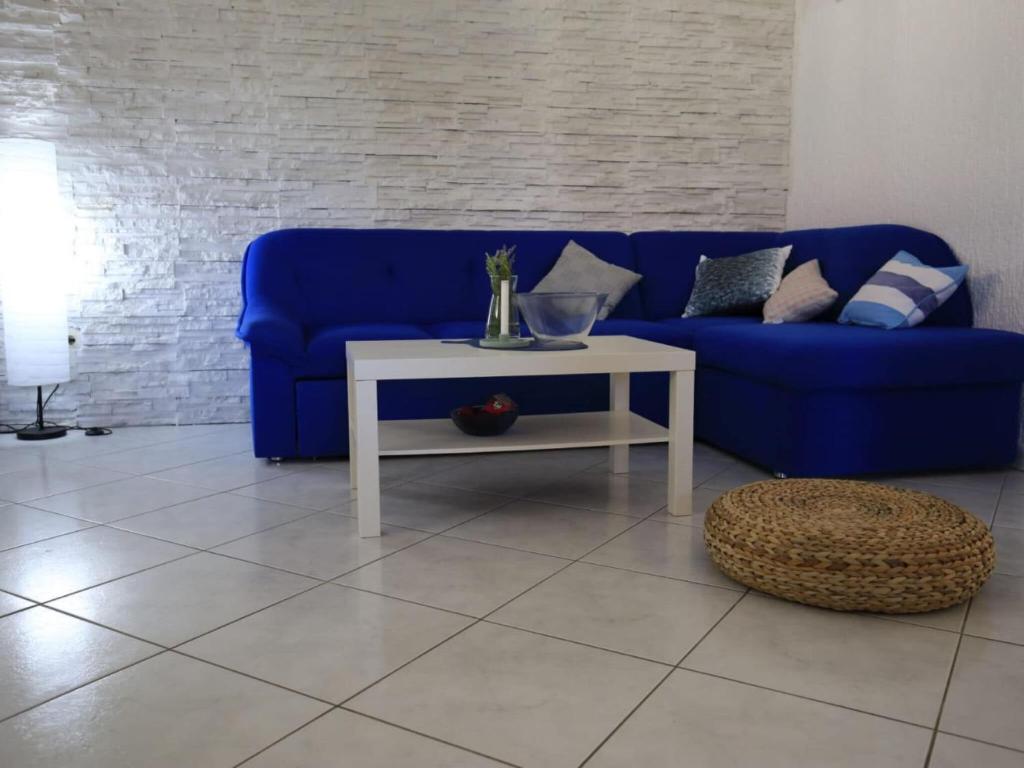 a blue couch and a white table in a living room at Apartment Barbara - Two Bedroom apartment with Terrace in Vir