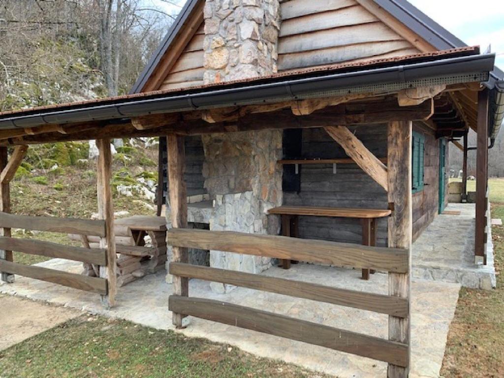 a log cabin with a roof and a fence at Holiday Home Anka in Gospić