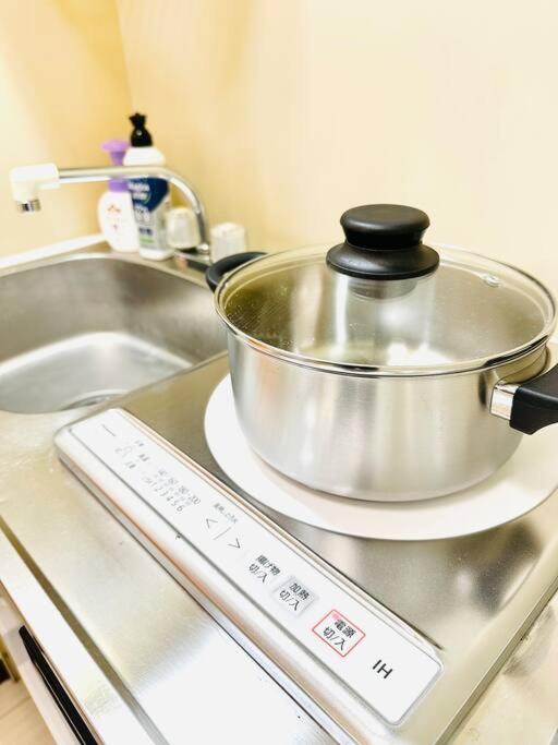 a pot on top of a stove with a thermometer at 301号室駅2分格安和室民泊専用ミニキッチンとバスルーム付きアクセス抜群 in Osaka