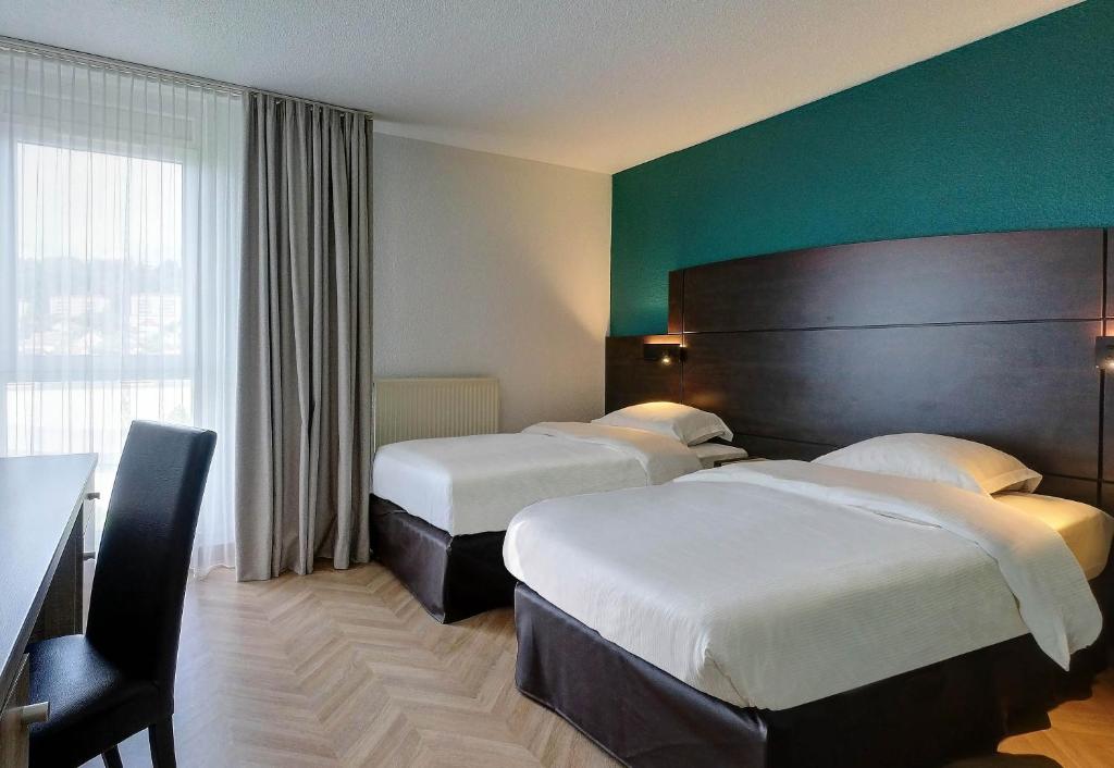 Postel nebo postele na pokoji v ubytování B&B HOTEL Montbéliard-Sochaux