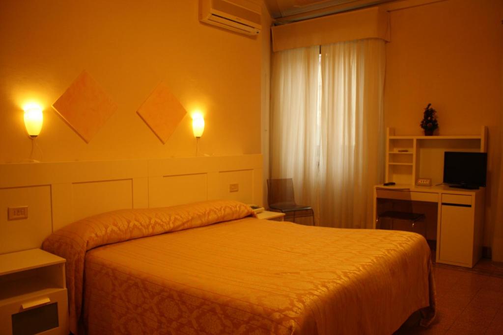 Postel nebo postele na pokoji v ubytování Albergo Il Giglio