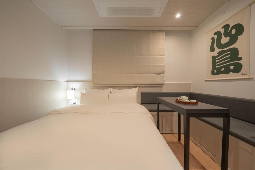Postel nebo postele na pokoji v ubytování Simdo Hotel&Spa Sillim by Aank