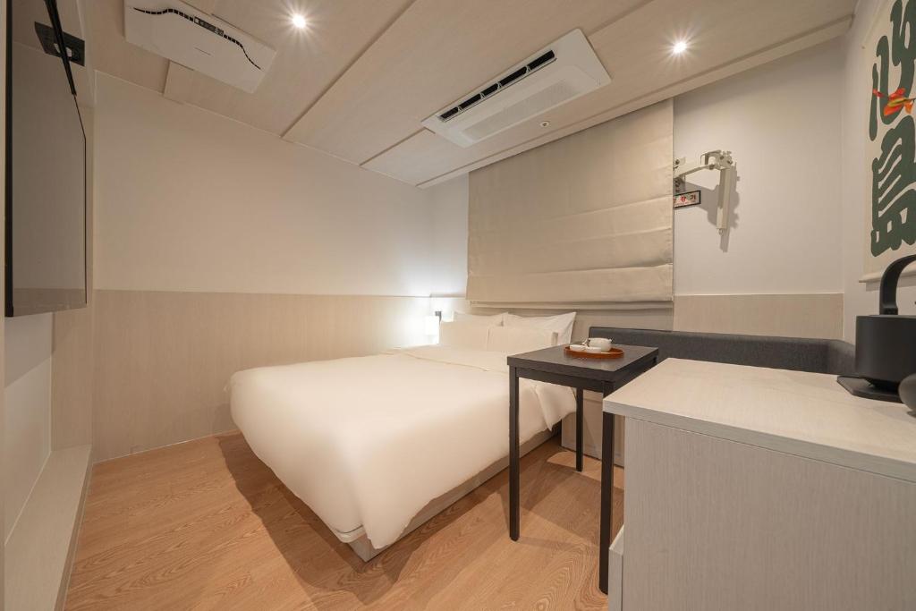 Postel nebo postele na pokoji v ubytování Simdo Hotel&Spa Sillim by Aank