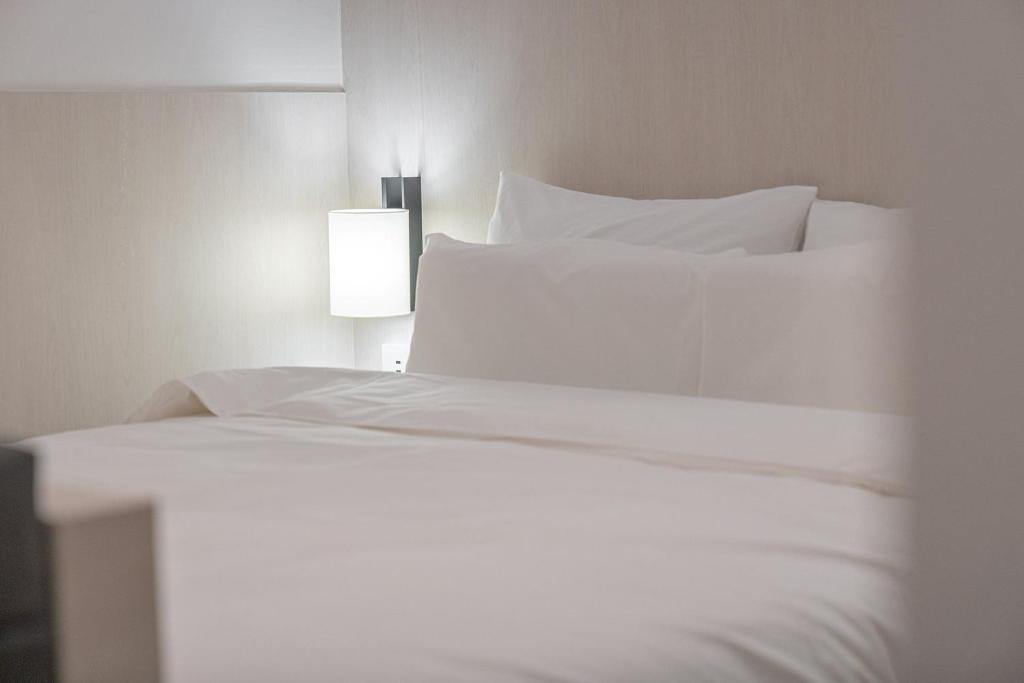 Postel nebo postele na pokoji v ubytování Simdo Hotel&Spa Sillim by Aank