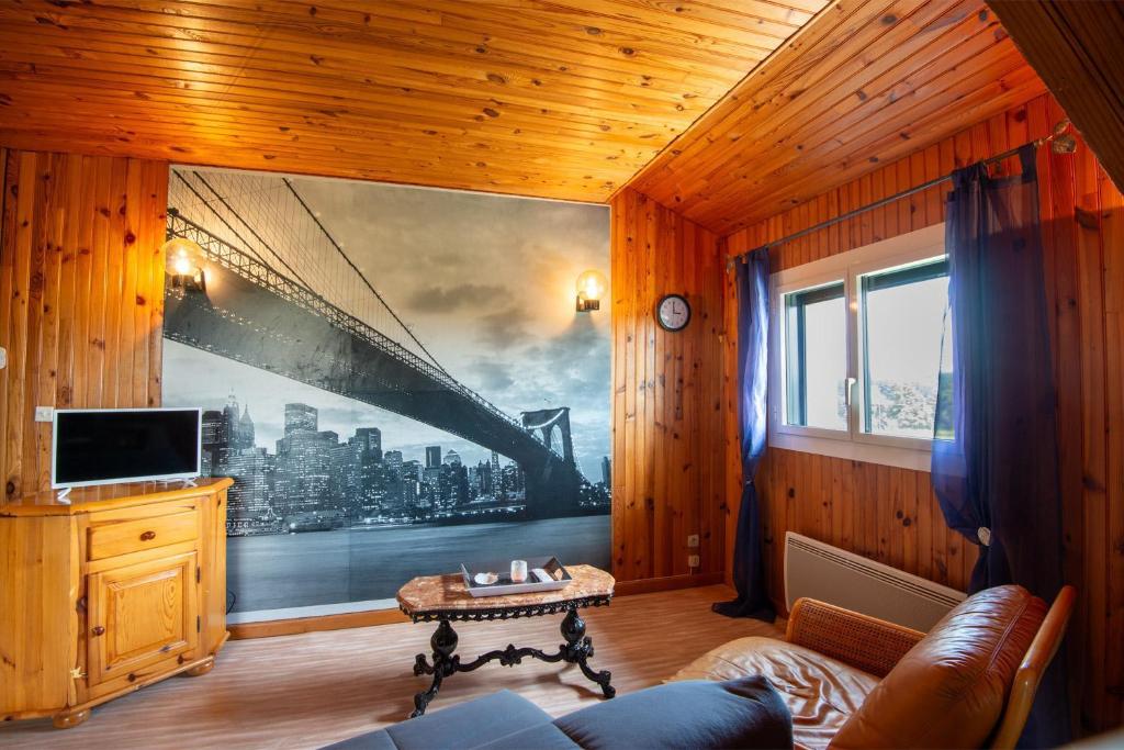 - un salon orné d'une grande peinture murale dans l'établissement Gîte Appartement 4/6 personnes, à Aumont-Aubrac