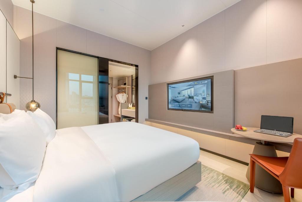 TV a/nebo společenská místnost v ubytování ONESS Executive Hotel Guangzhou Huangpu Luogang