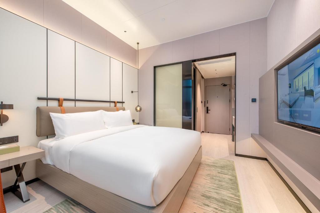 Postel nebo postele na pokoji v ubytování ONESS Executive Hotel Guangzhou Huangpu Luogang