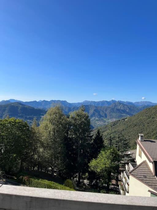a view of a mountain with trees and houses at Casetta bella vista in Aviatico
