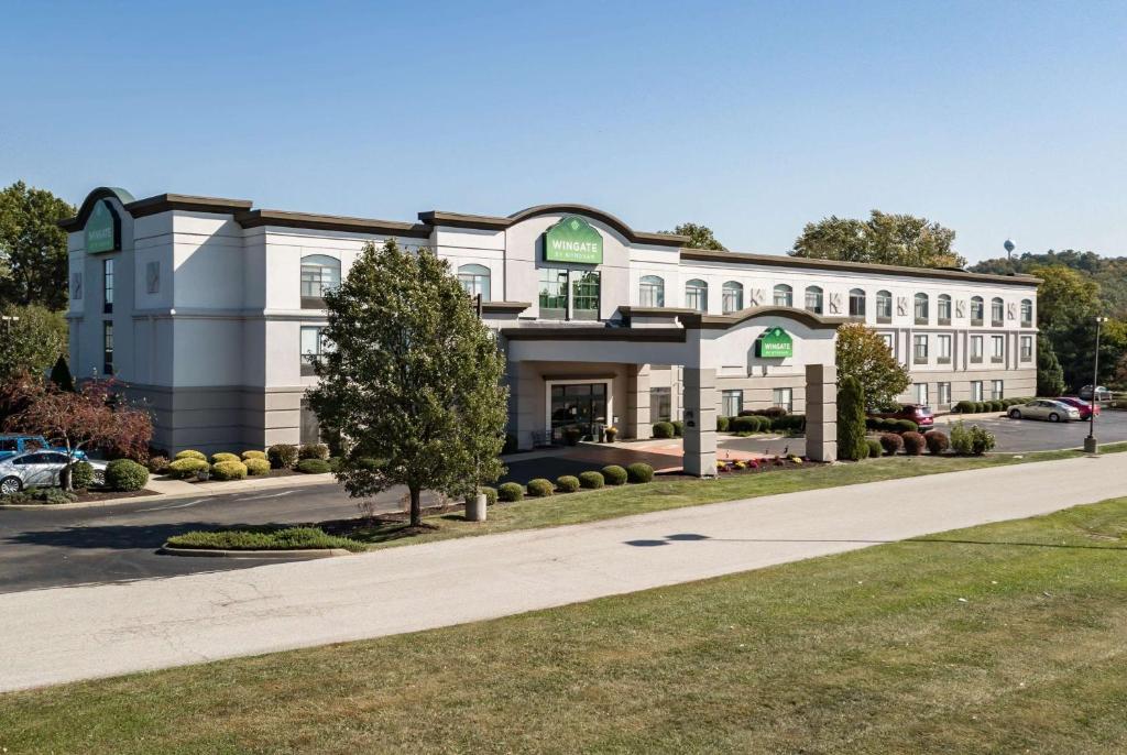a large white building on a street at Wingate by Wyndham Parkersburg-Vienna in Parkersburg