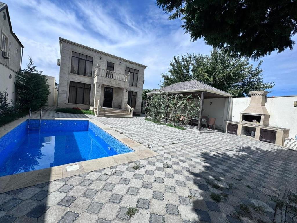 a house with a swimming pool in front of a house at Villa in Buzovna