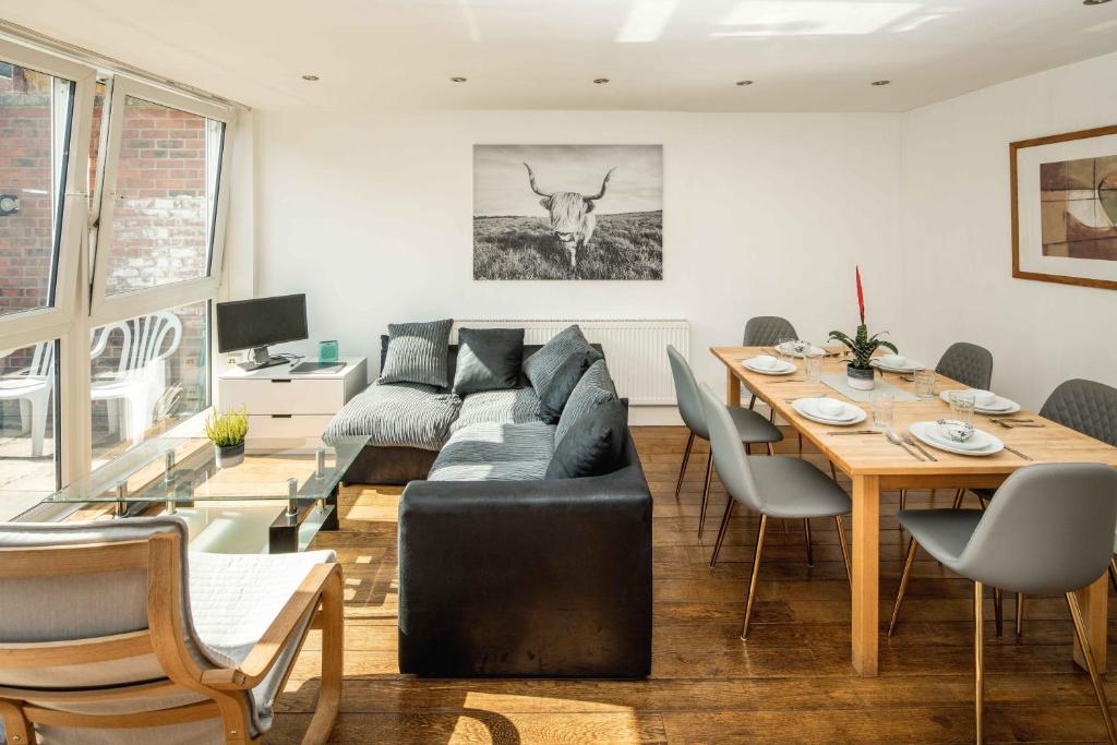 a living room with a couch and a table at Hoxton Rooms in London