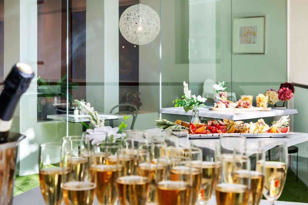 a table with glasses of champagne and a buffet of food at Best Western Plus Park City Solna in Solna