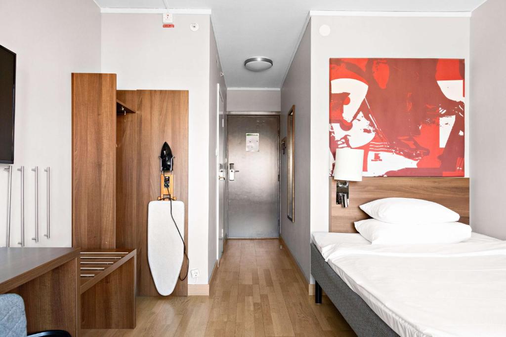 a bedroom with a large white bed in a room at Best Western Plus Park City Solna in Solna