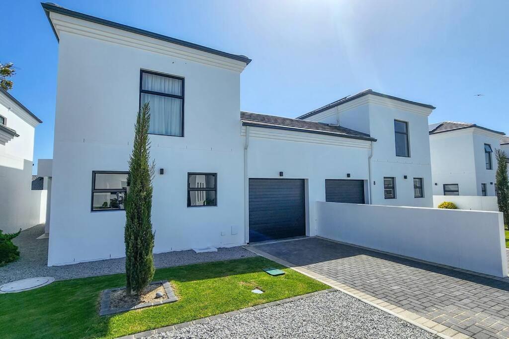 a white house with a garage and a driveway at 10 Seaview Close, Shelley Point in St Helena Bay
