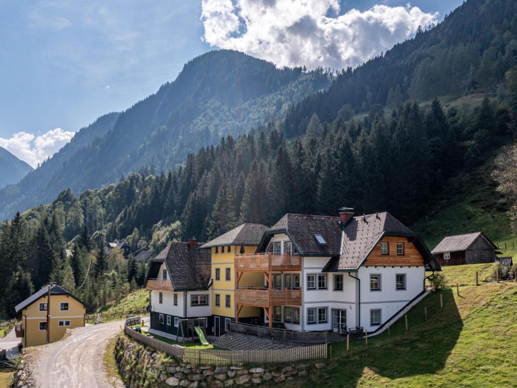 a large house on the side of a mountain at Apartment Grimming by Interhome in Kleinsölk