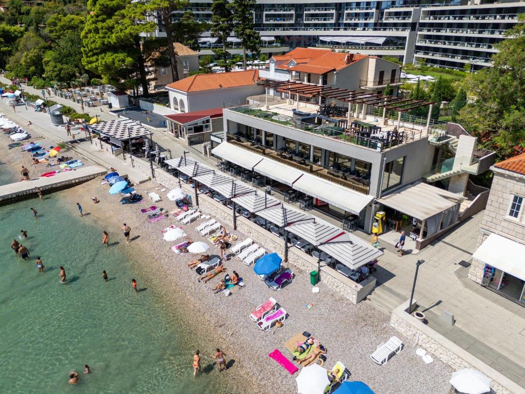 an overhead view of a beach with people in the water at Sun & Sea Residence in Mlini