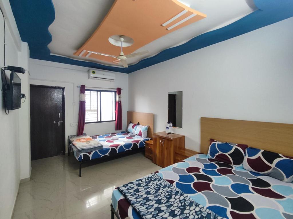 Postel nebo postele na pokoji v ubytování Ambient Homestay by NESTEASY