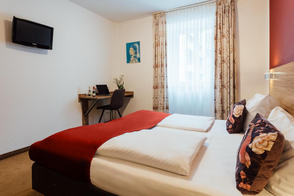 Postel nebo postele na pokoji v ubytování Hotel Andra München