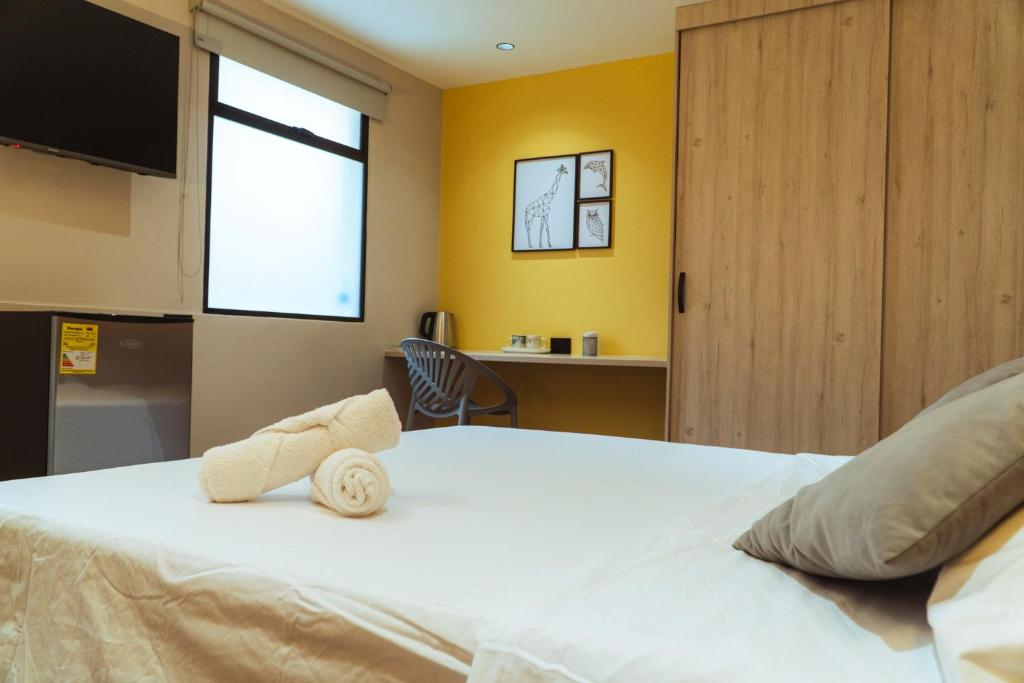 Una cama o camas en una habitación de Casa Origo Hospedaje