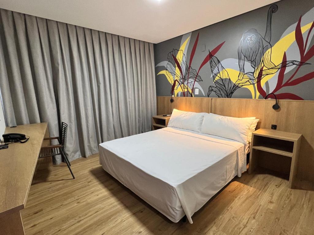 Postel nebo postele na pokoji v ubytování Ramada Encore Ponta Grossa