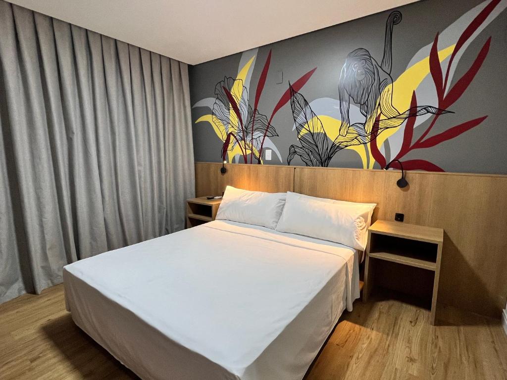 Postel nebo postele na pokoji v ubytování Ramada Encore Ponta Grossa
