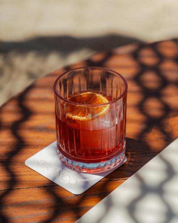 a glass of tea sitting on top of a table at Branco Mykonos in Platis Gialos