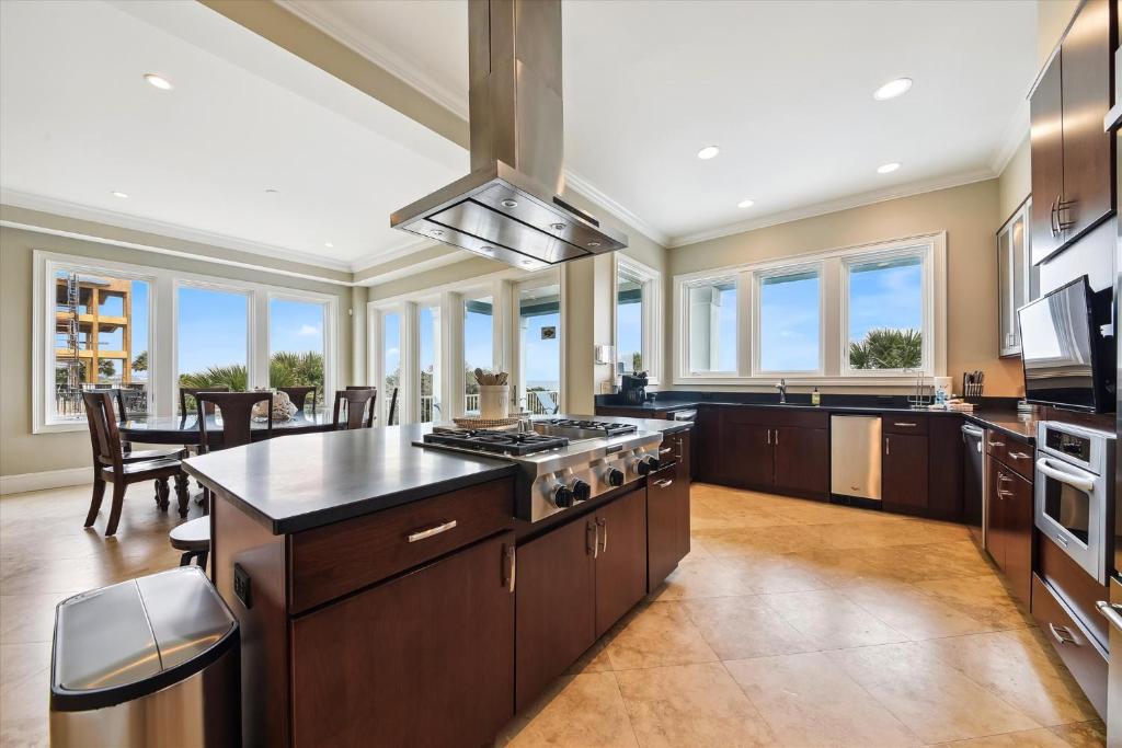 a large kitchen with a stove and a dining room at 27 Singleton Beach- Oceanfront, Private Pool, Pool Table, FREE Activities Included in Hilton Head Island
