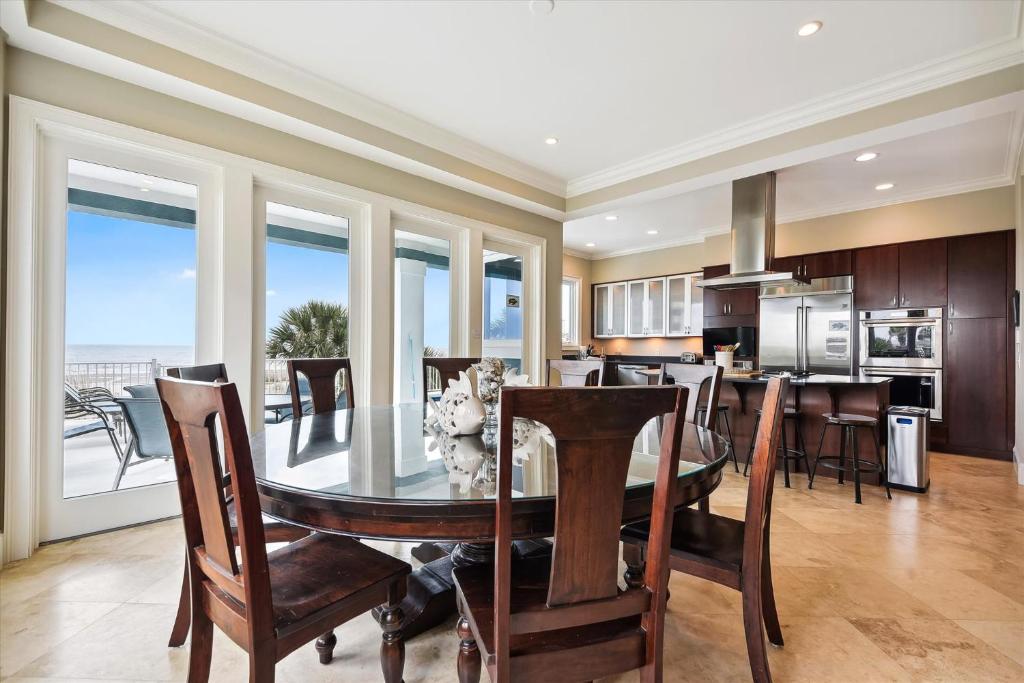 a dining room and kitchen with a table and chairs at 27 Singleton Beach- Oceanfront, Private Pool, Pool Table, FREE Activities Included in Hilton Head Island