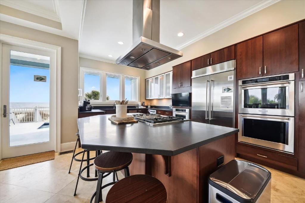 a kitchen with a island with a counter top at 27 Singleton Beach- Oceanfront, Private Pool, Pool Table, FREE Activities Included in Hilton Head Island